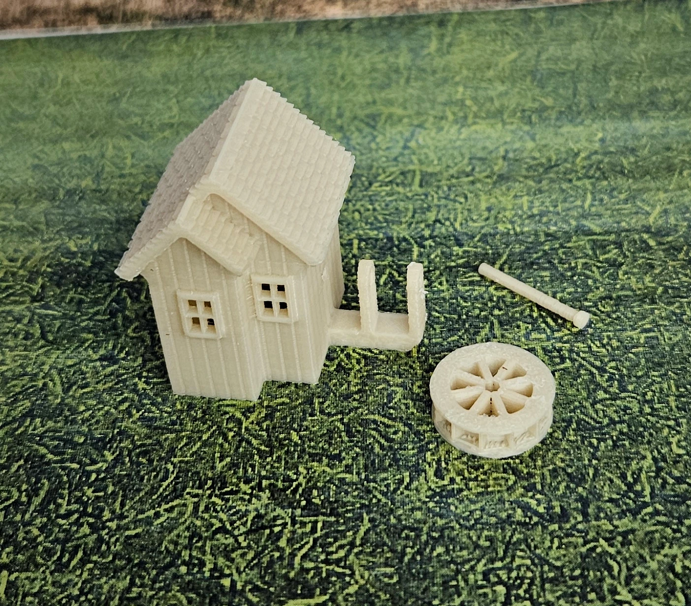 N scale waterwheel with medium building on display